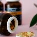 Close-up of omega-3 capsules and bottles on a pink background, ideal for health and wellness themes.